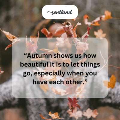 Couple embracing amidst fall foliage.