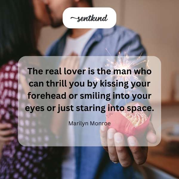 Close-up of a woman's forehead being gently kissed, highlighting the eyes and surrounding space.