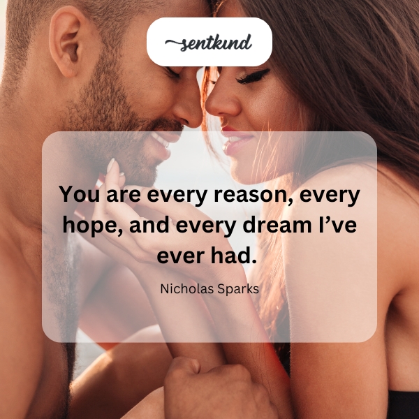 A couple embracing tenderly at sunset, symbolizing profound love and shared dreams.