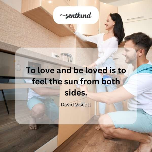 A couple embraces warmly under a radiant sun.