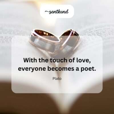 A hand writes in a notebook illuminated by a soft glow, symbolizing creative expression inspired by emotion.