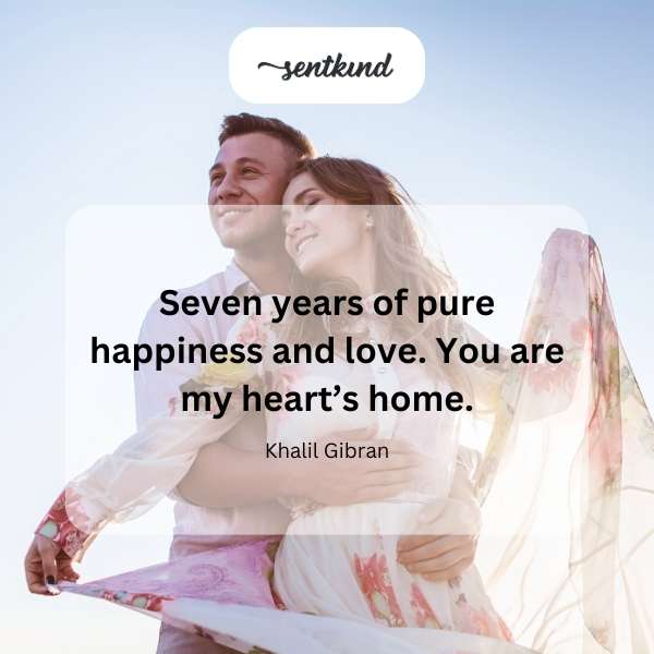 A couple gazes lovingly at each other against a soft, blurred background.
