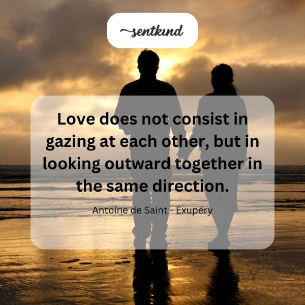 A couple gazes towards a distant horizon, symbolizing shared vision.