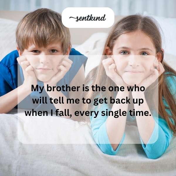 Two brothers helping each other stand up after falling.