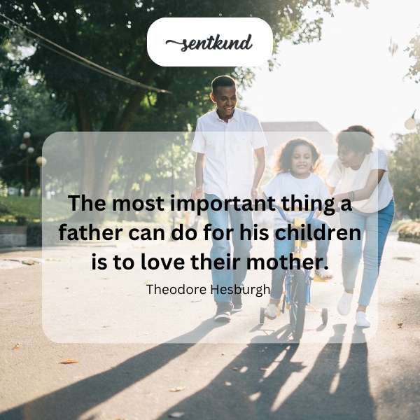A father lovingly embraces his wife while their children play happily nearby.