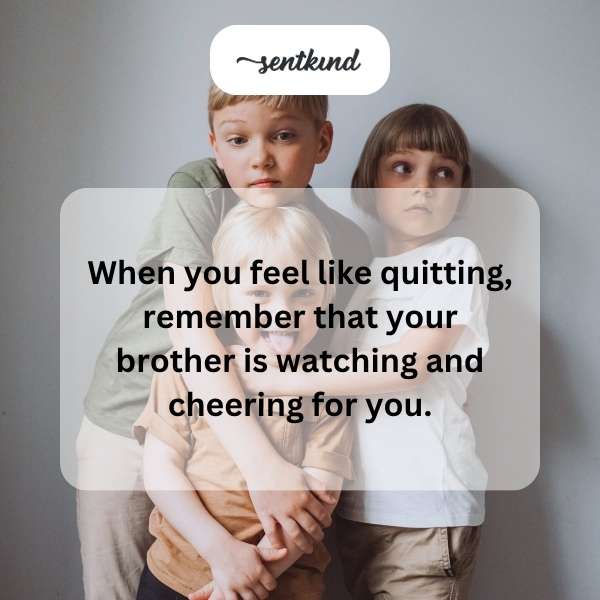 A young boy is running a race, with his older brother cheering him on from the sidelines.