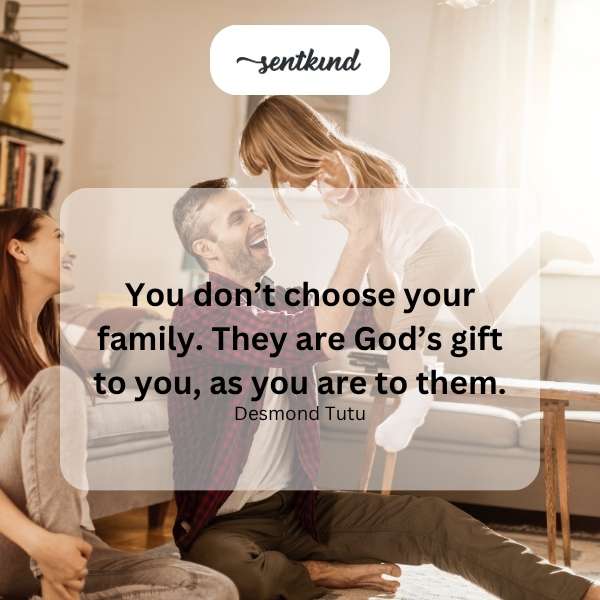 A diverse group of people are hugging and smiling, representing a family bond.