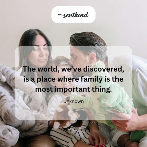 A diverse group of people of all ages are embracing, representing a close-knit family.