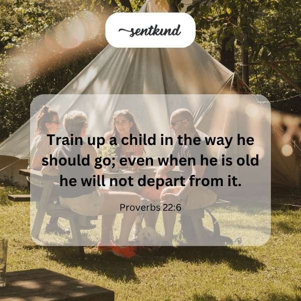 A parent gently guides a young child as they walk together on a path.
