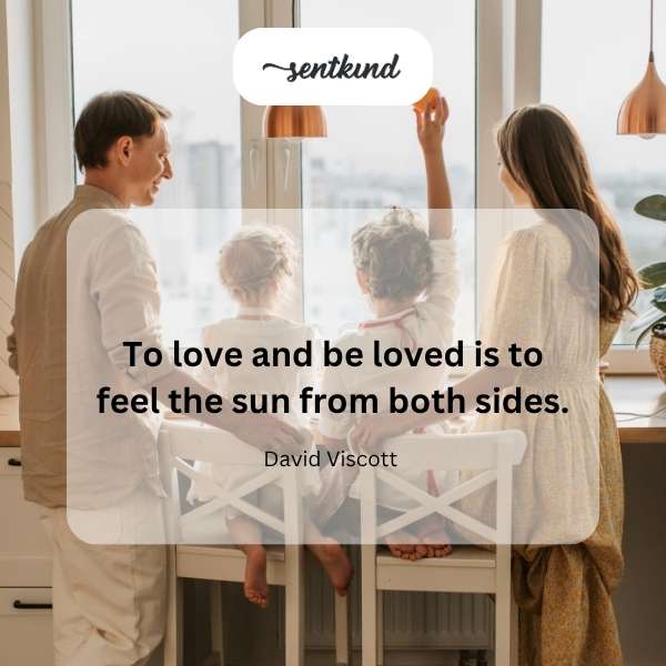 A golden sun shines brightly on two people embracing warmly.