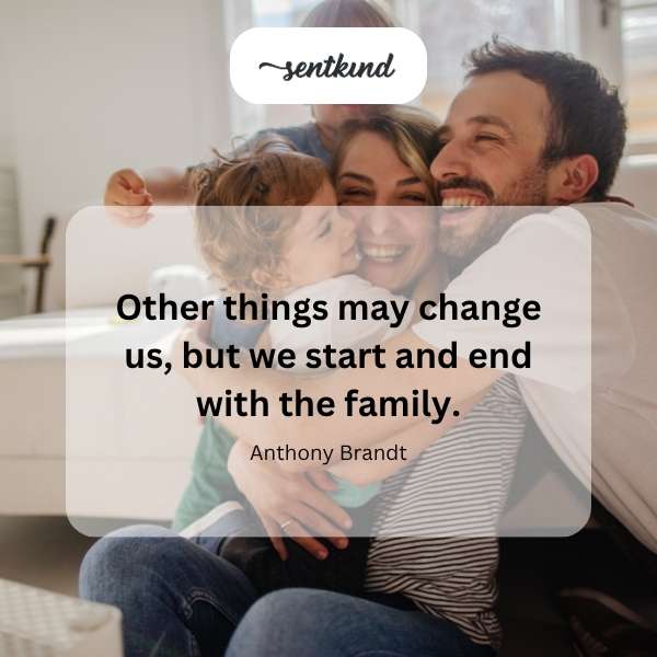 A multigenerational family is embracing in a warmly lit home.