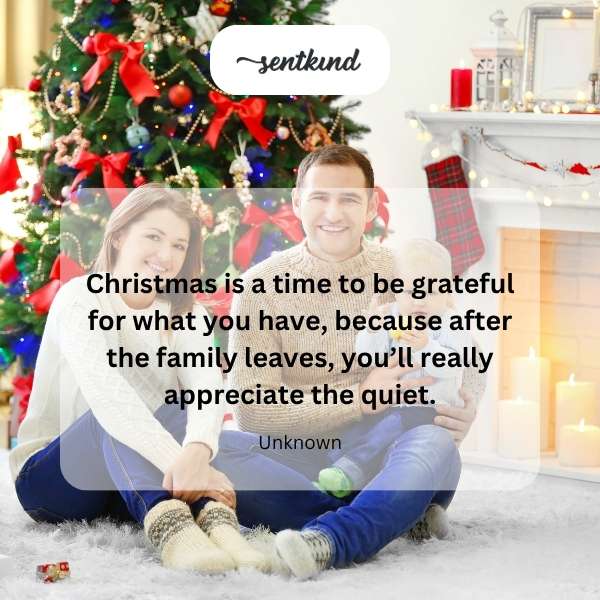 A warmly lit, empty living room with Christmas decorations after a family gathering.