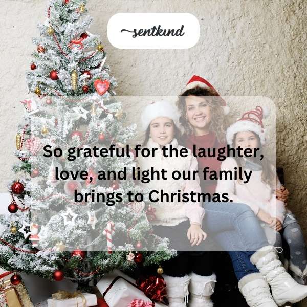 A family joyfully gathers around a Christmas tree, their faces lit with happiness.