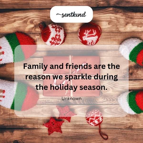 A group of diverse people are smiling and laughing together during a holiday gathering.