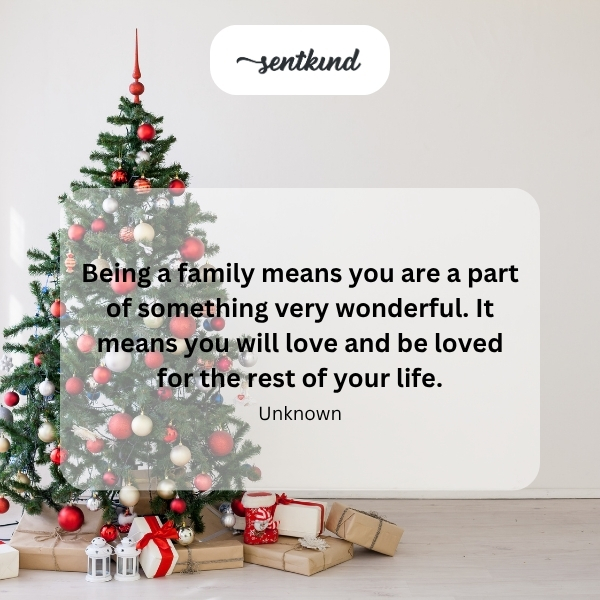 A diverse family of four is hugging tightly in a brightly lit living room.