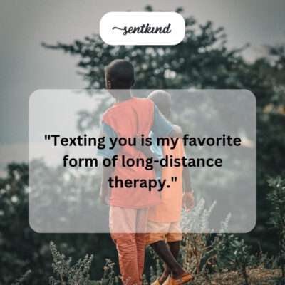 A person smiling while texting on their phone.