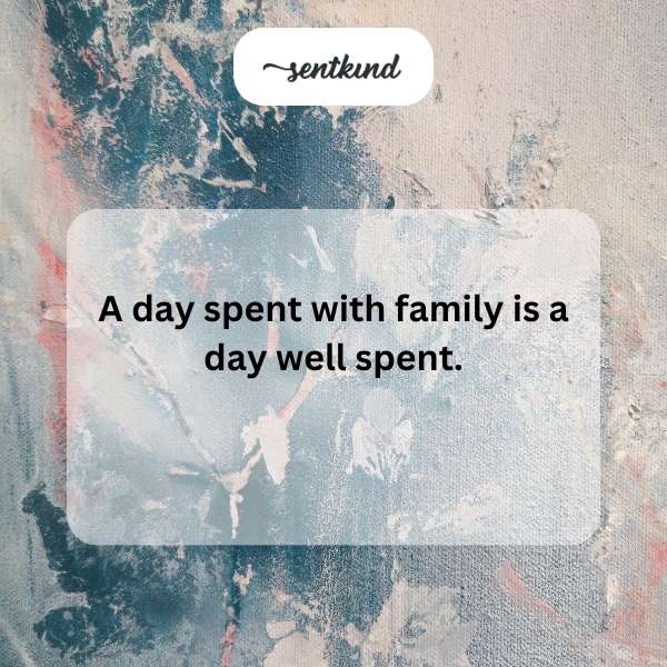 A multigenerational family is gathered closely together, smiling warmly.