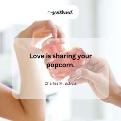 Two hands reach into a large bucket of popcorn, symbolizing sharing.