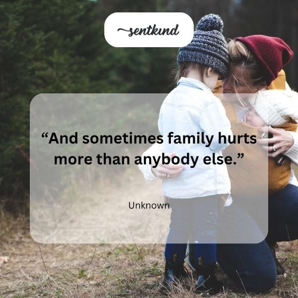 A family sits together on a couch, some smiling warmly while others display subtle expressions of sadness or unease.