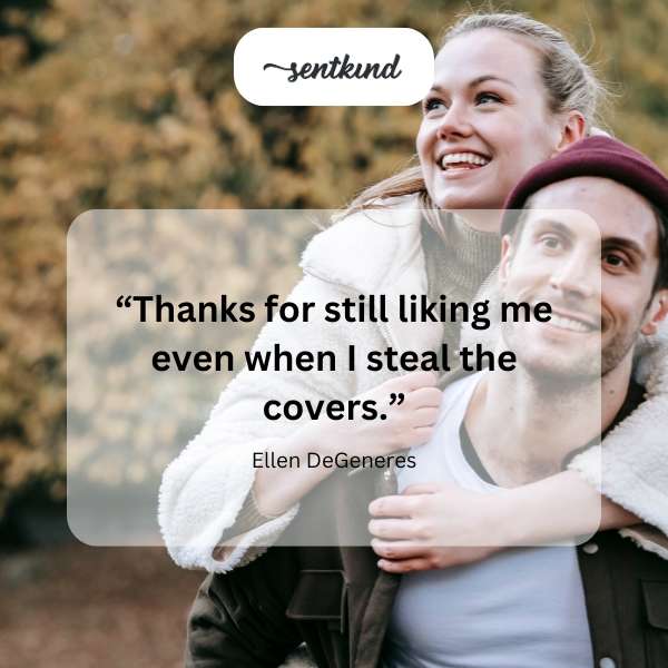 A person playfully pulling bed covers off another person in bed.