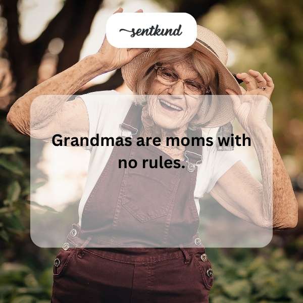 A happy grandmother and grandchild share a large bowl of ice cream together, smiling mischievously.