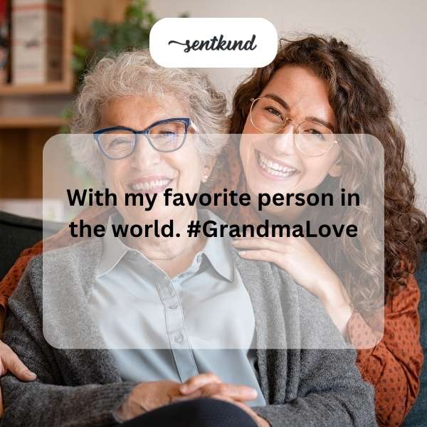 A grandchild is smiling widely while sitting next to their beloved grandmother.