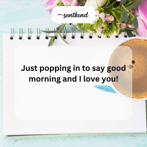 A steaming mug rests on a table beside a handwritten note with a heart drawn on it in soft morning light.