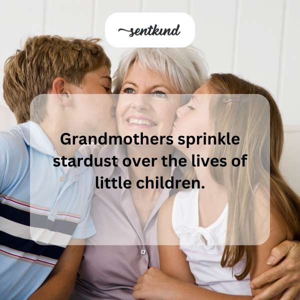 A kind grandmother gently holds a young child's hand as they share a quiet, loving moment.