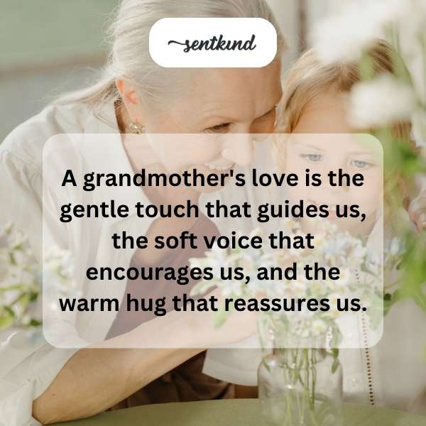 A grandmother gently holds her grandchild's hand while smiling lovingly.