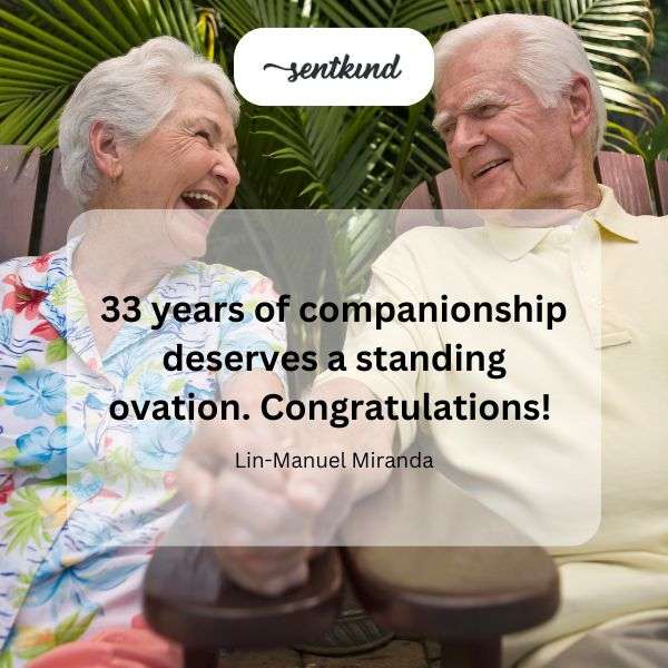 A jubilant couple celebrates a milestone anniversary with a cheerful audience.