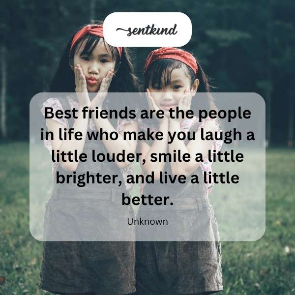 A candid photo shows two cheerful friends smiling and laughing warmly together.