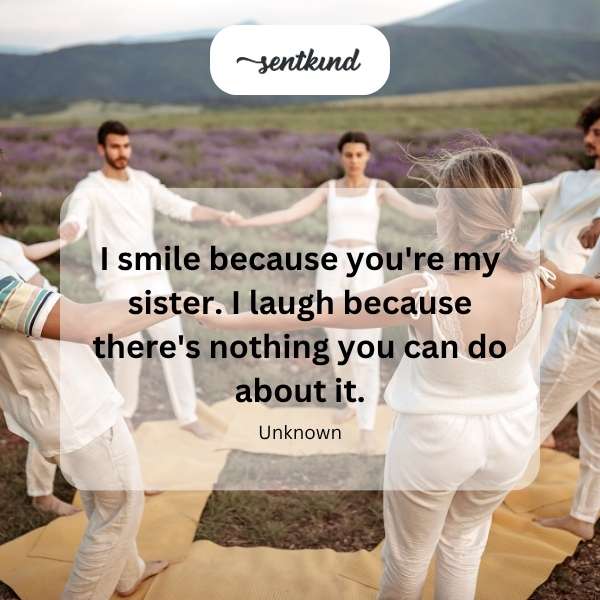 A candid photograph captures two sisters sharing a moment of laughter while embracing outdoors.