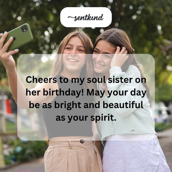 Two joyful women, celebrating a birthday with smiles and raised glasses.