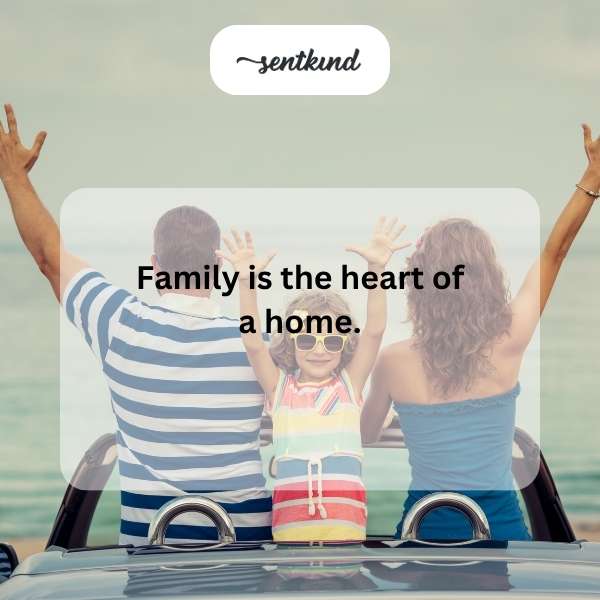 A diverse family embraces warmly in a sunlit park.