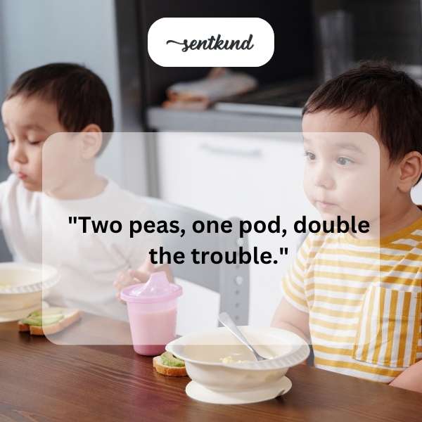 Identical twins are cheek to cheek, looking mischievously at the viewer.