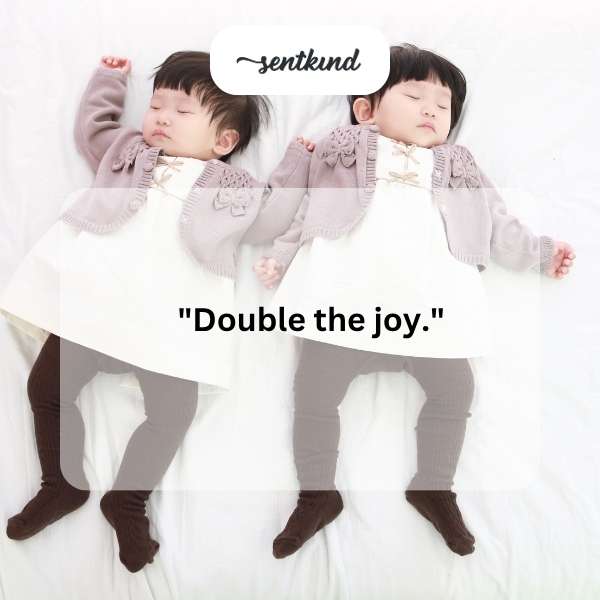 Two identical twin toddlers are laughing while playing together in a sunlit park.