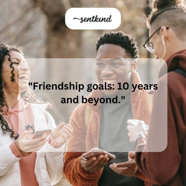Two friends are laughing while holding balloons and cake, celebrating a 10th anniversary or birthday.