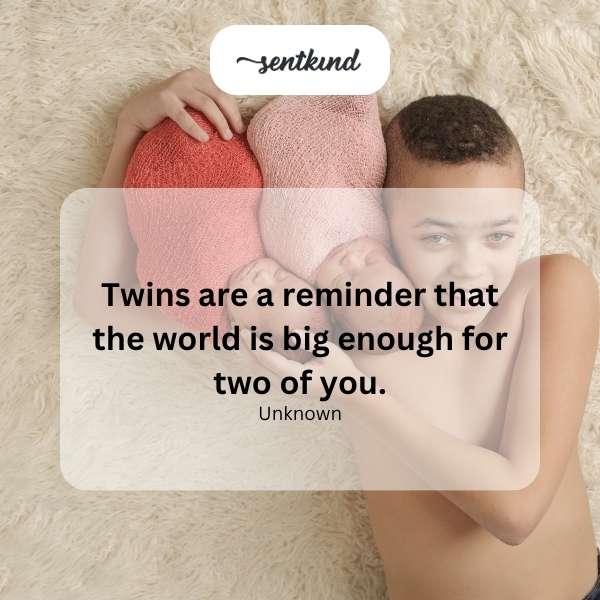 Identical twins smiling and holding hands in a sunlit park.