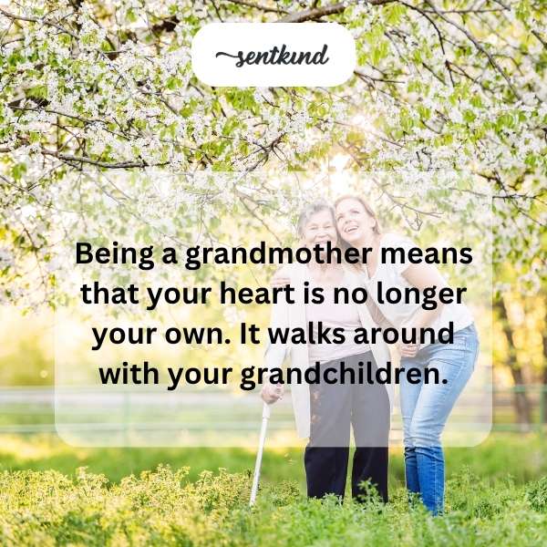 An older woman with a warm smile holds the hands of two young children, walking down a sunny path.