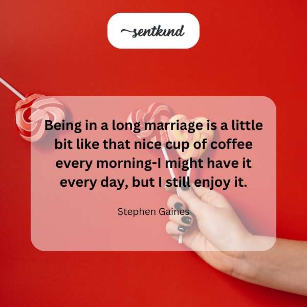 A couple smiles warmly while holding steaming cups of coffee.