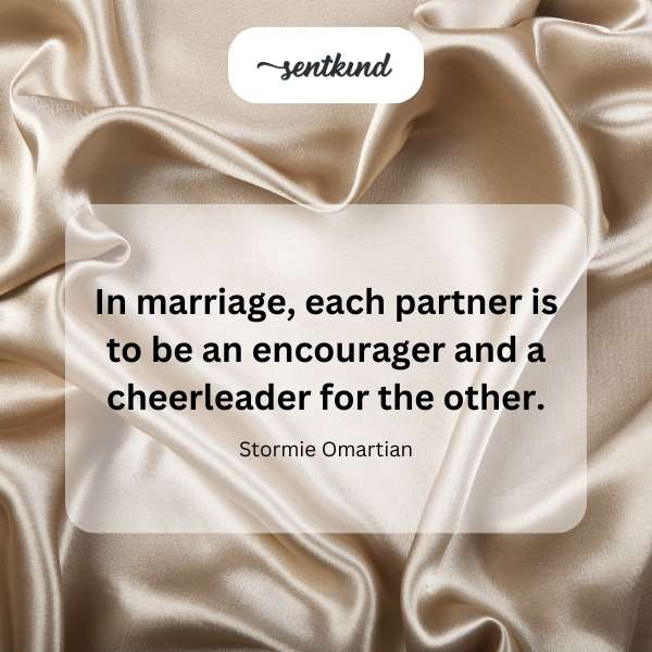 A couple holding hands and smiling at each other during their wedding ceremony.