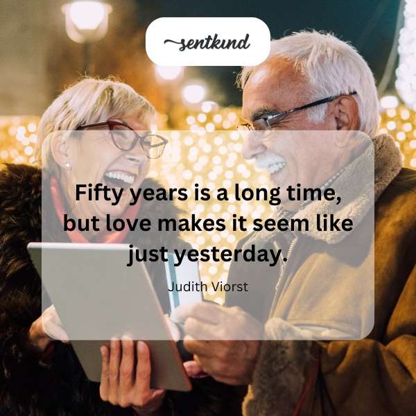 An elderly couple holding hands, symbolizing enduring love and the passage of time.