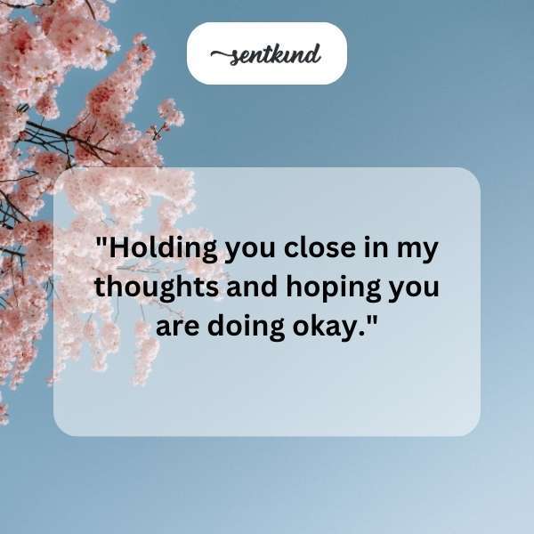 A comforting hand rests on another's arm in a gesture of sympathy and support.