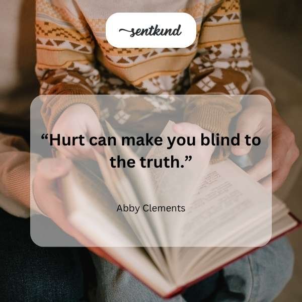 A solitary figure sits alone on a park bench, looking distant and contemplating.