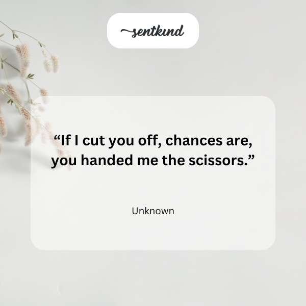 A small group of friends sits together laughing warmly on a sunny day.