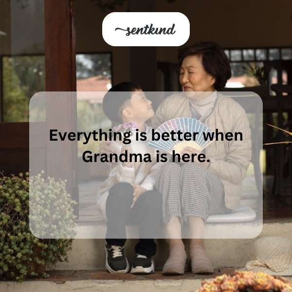 A smiling grandmother sits in a cozy armchair, surrounded by her happy grandchildren who are looking up at her.