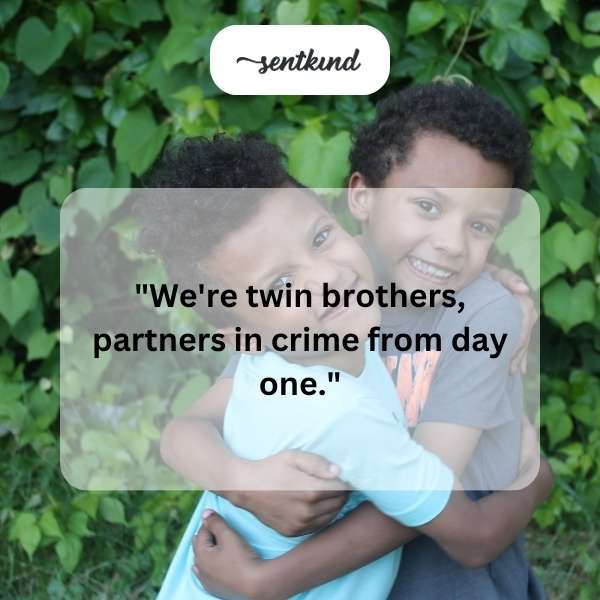 Two identical men stand side-by-side with mischievous grins.