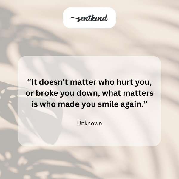 A person sitting alone, looking contemplatively out a window at twilight, a hand gently touching their chest as if feeling emotional pain.