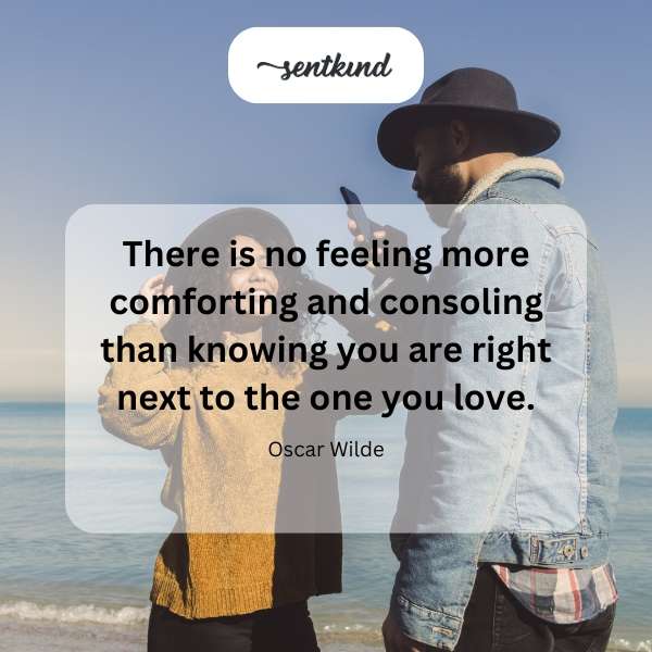 A couple is embracing tenderly in a softly lit setting.