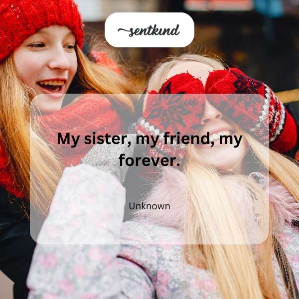 Two smiling sisters hug tightly outdoors during golden hour, one resting her head on the other's shoulder.